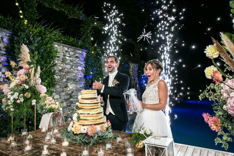 Married couple with a wedding cake and fireworks