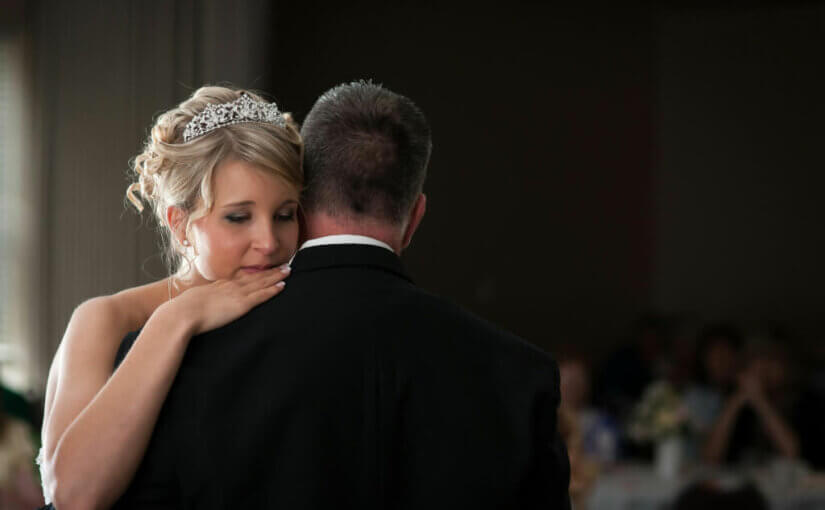 Bride hugging her father