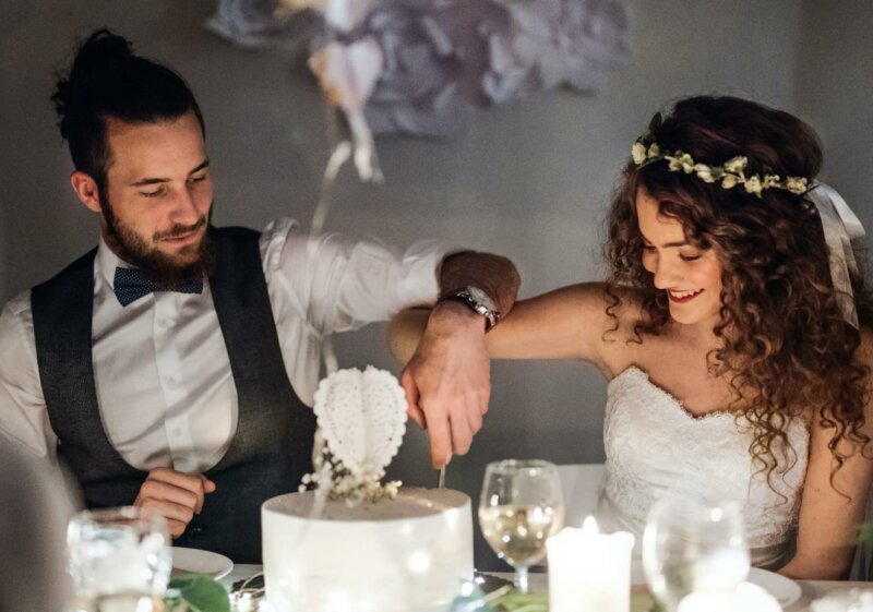 Couple en train de couper un gâteau de mariage