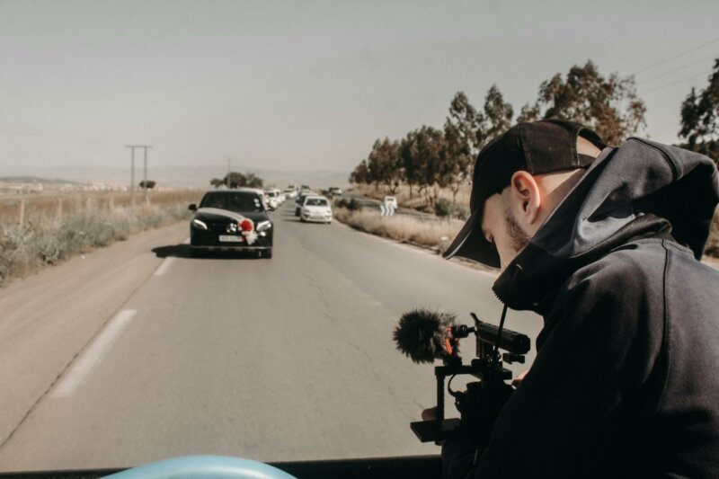 Wedding videographer filming the wedding car