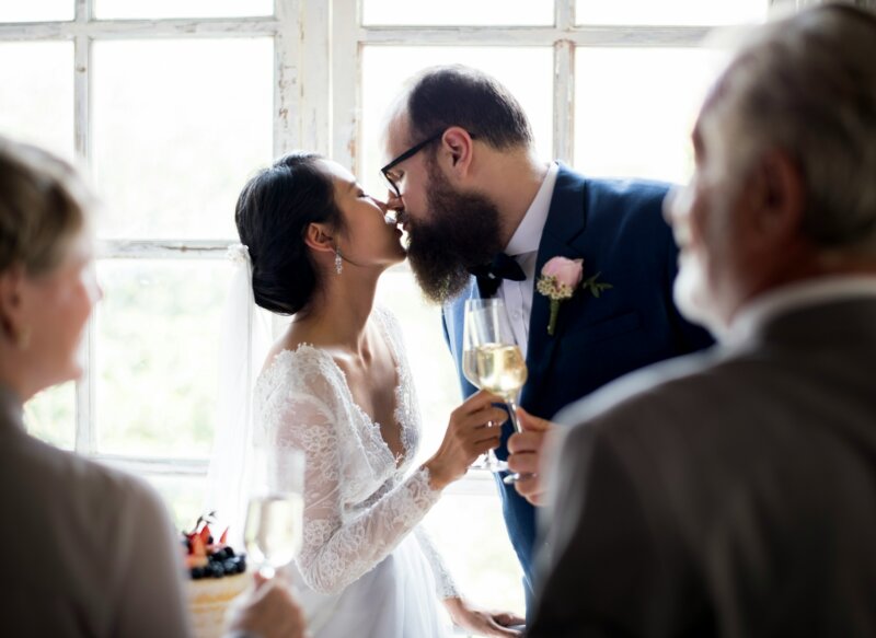 Married couple toasting and kissing