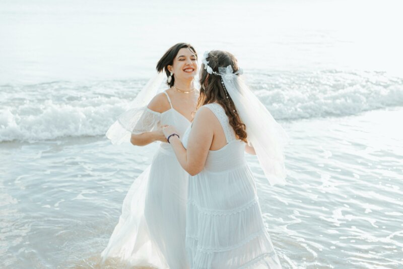 Dancing couple of brides on a beach