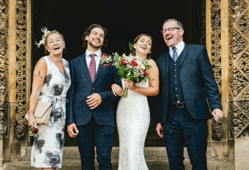 Married couple laughing with parents