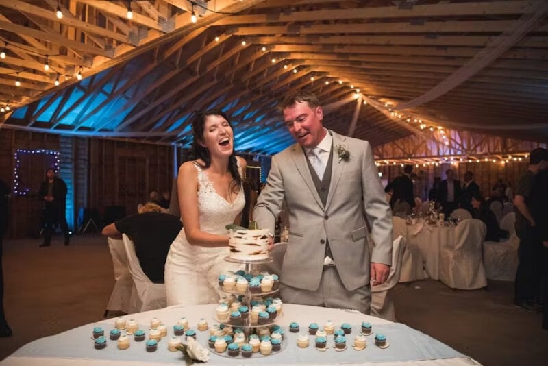 Newly weds cutting the cake and having fun