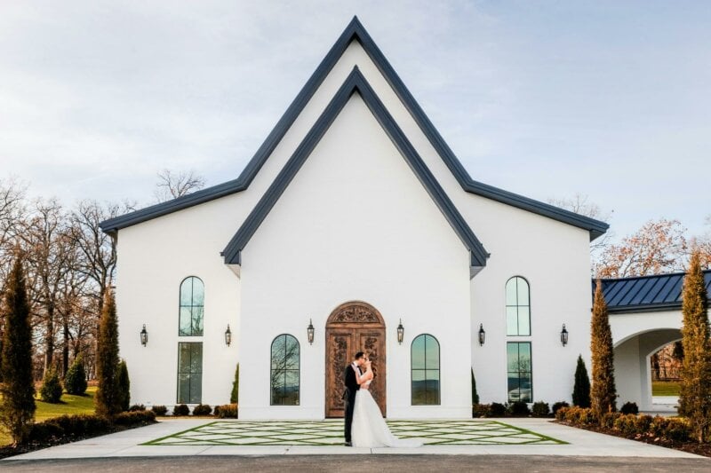 Married couple in front of a white church