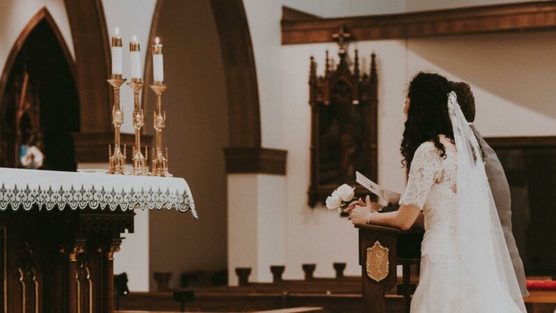 Couple praying during a church wedding 