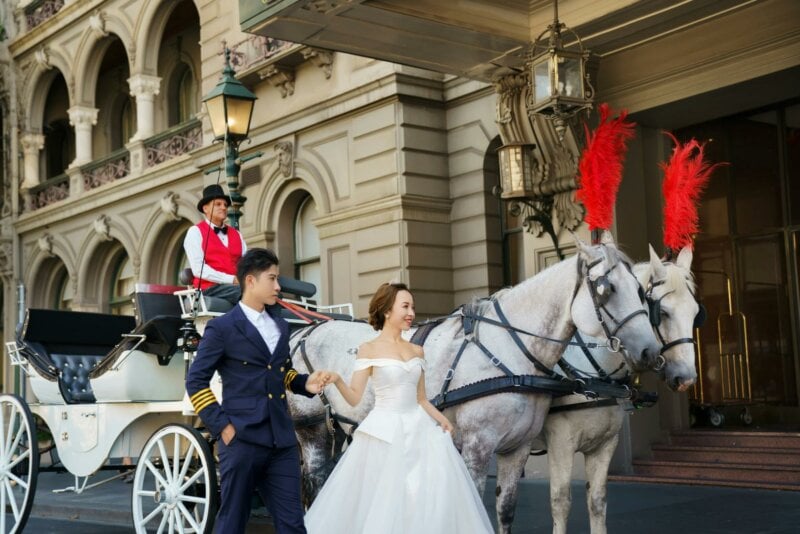 Married couple in front of a horse carriage