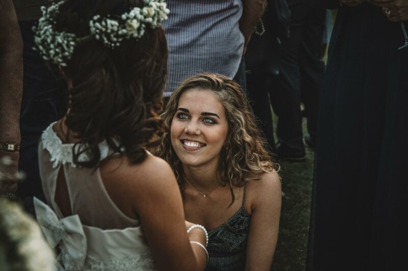 Bride smiling at her flower girl