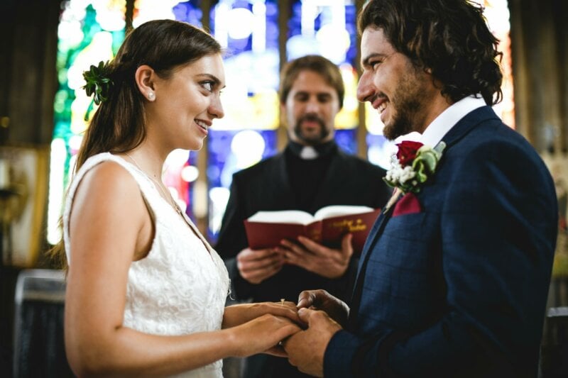 Couple getting married in a church with a priest reading