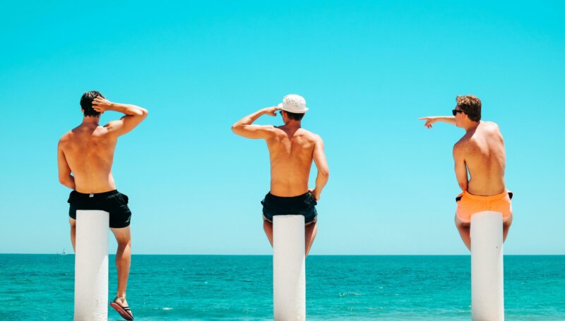 Trois amis sur des pilotis à la mer