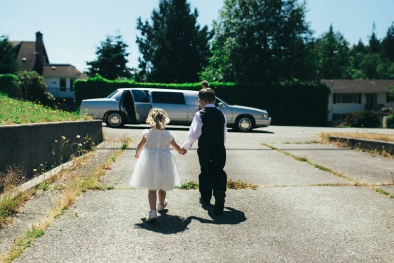 Children walking towards a limo