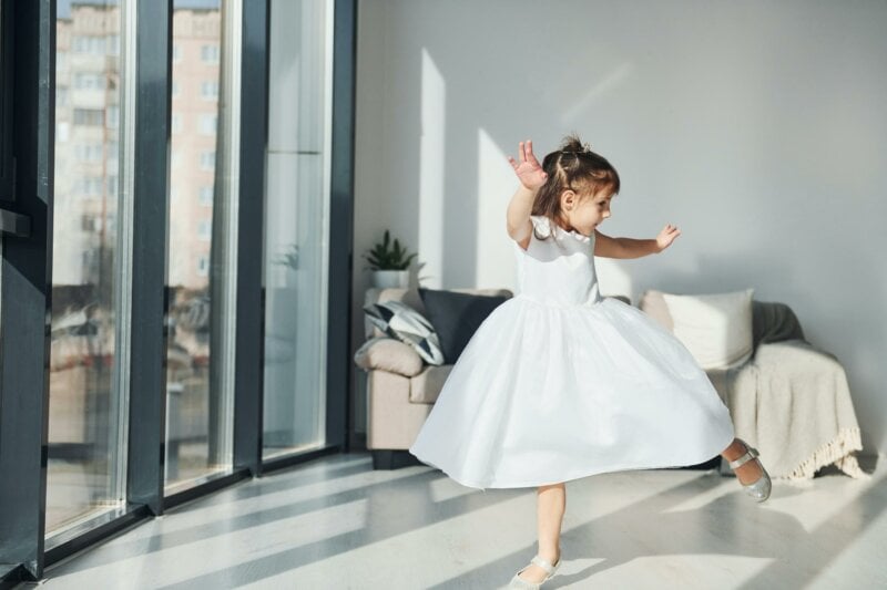 Dancing little girl in white