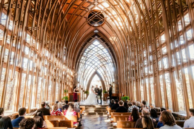 Couple getting married in a stunning wood cathedral