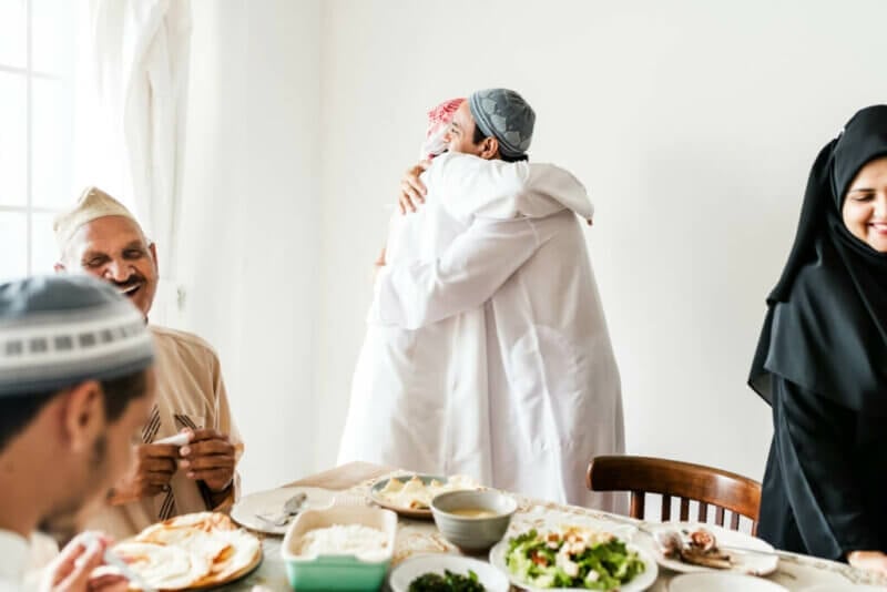 Two men hugging at a Muslim reception