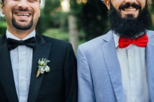 Two smiling men in a suit