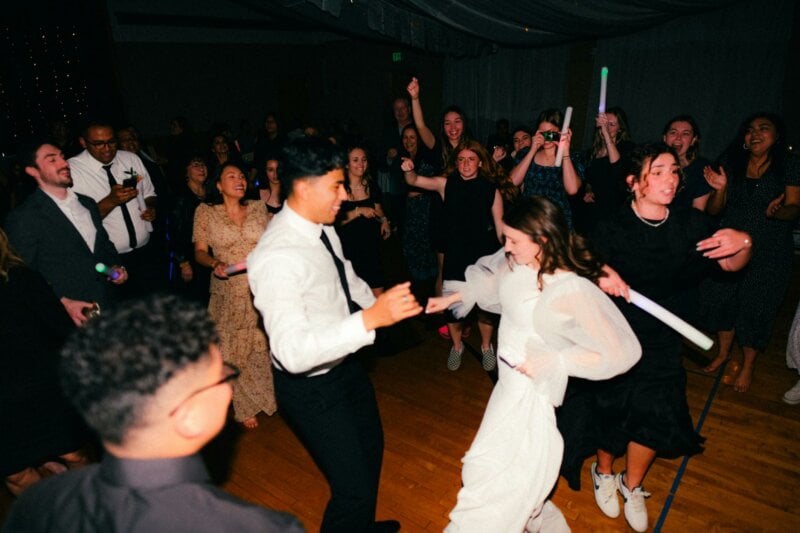 Dancing bride and groom with guests