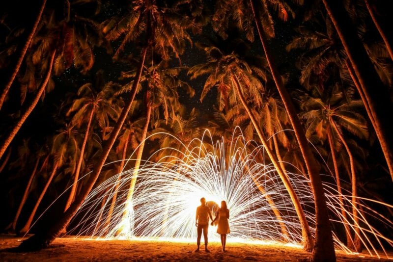 Couple with fireworks and palmtrees