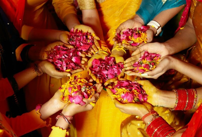 Hands holding colorful flowers