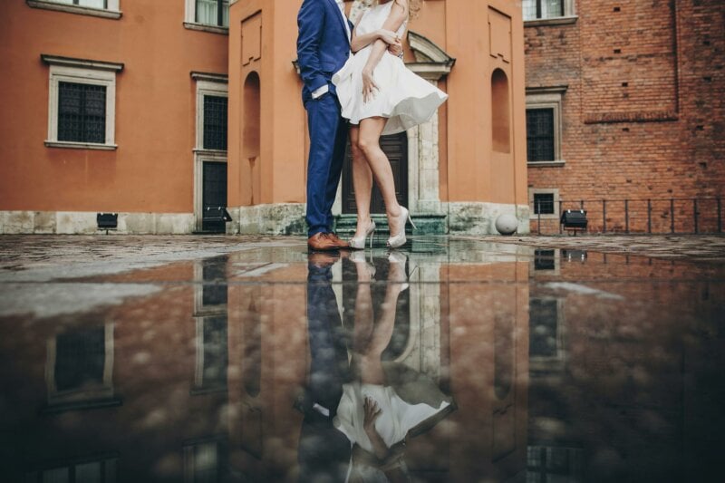 Legs of a married couple with water reflection