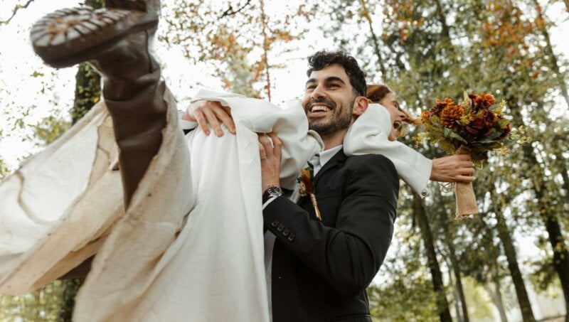 Groom lifting a bride outdoor