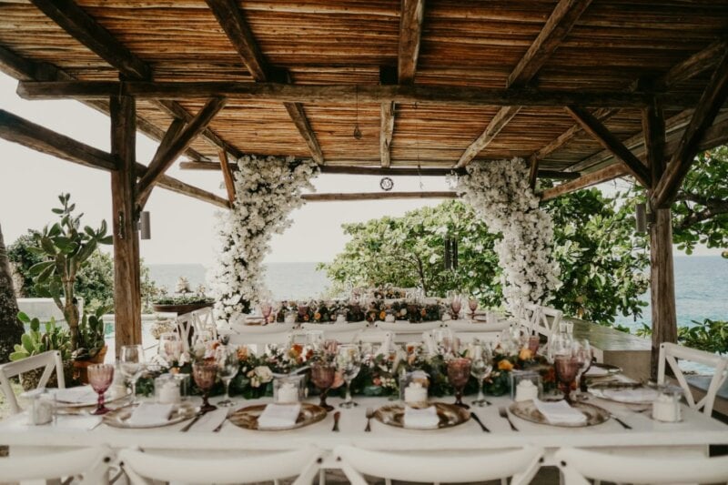 Beach wedding decor with tables and flowers