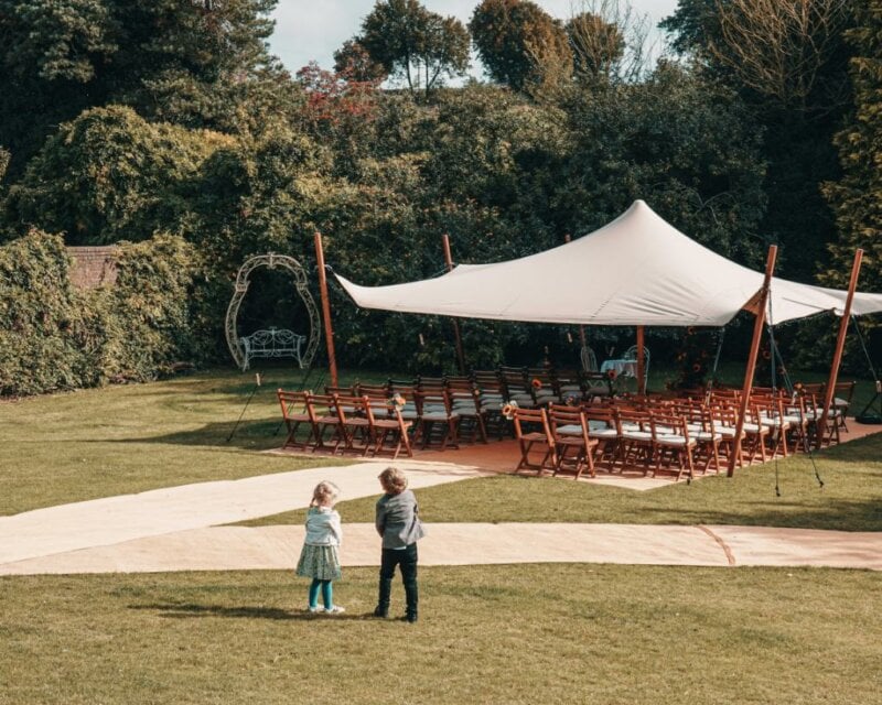 Two children in front of a wedding tent