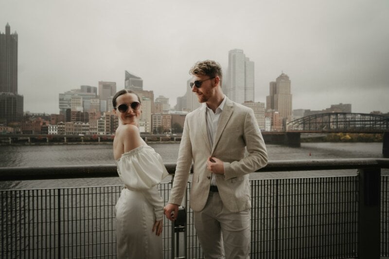 Married couple posing with a city background