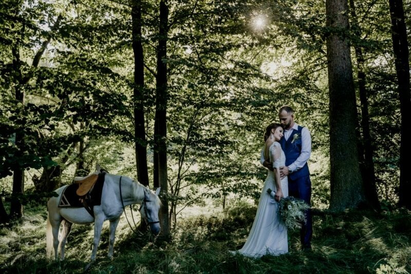 Couple with a horse in a forest