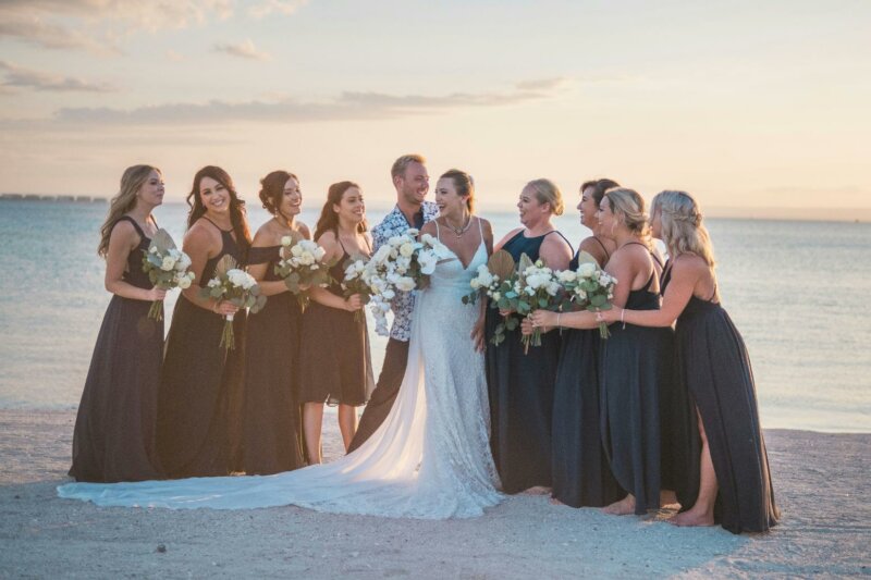 Bridesmaids and couple on a beach
