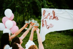 Women cheering to a bride to be sign