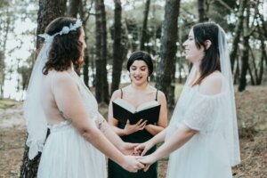 Two women getting married in a forest