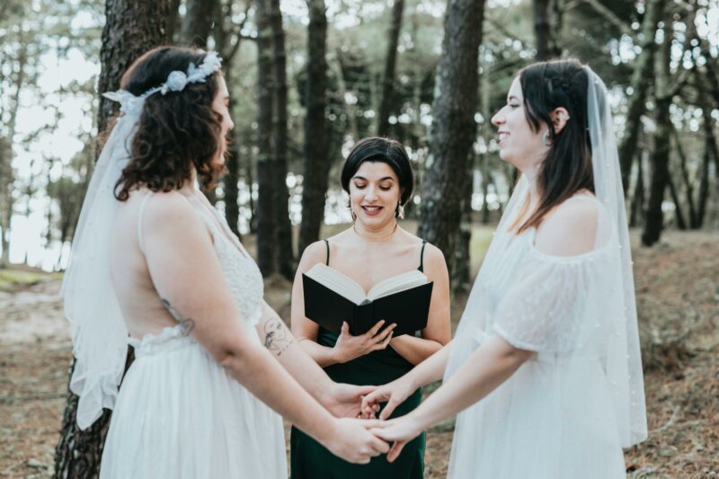 Two women getting married in a forest
