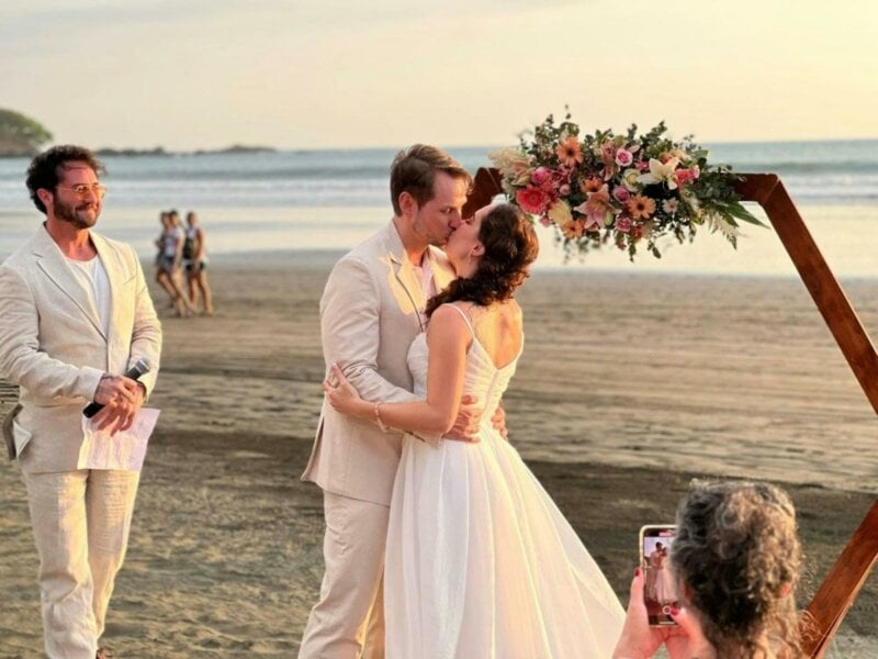 Married couple kissing on a beach