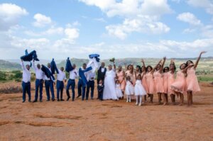 Group wedding picture in an outdoor setting