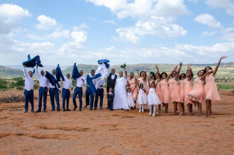 Group wedding picture in an outdoor setting