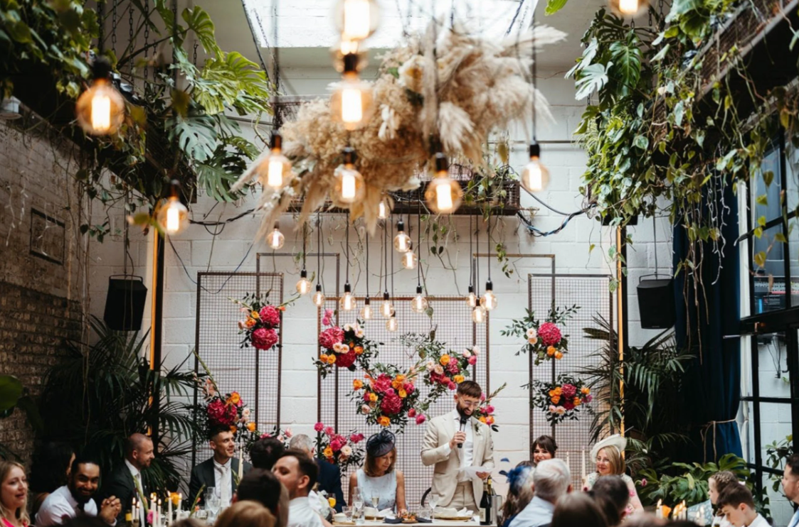 Speeches during a wedding breakfast inside a modern East London wedding event venue