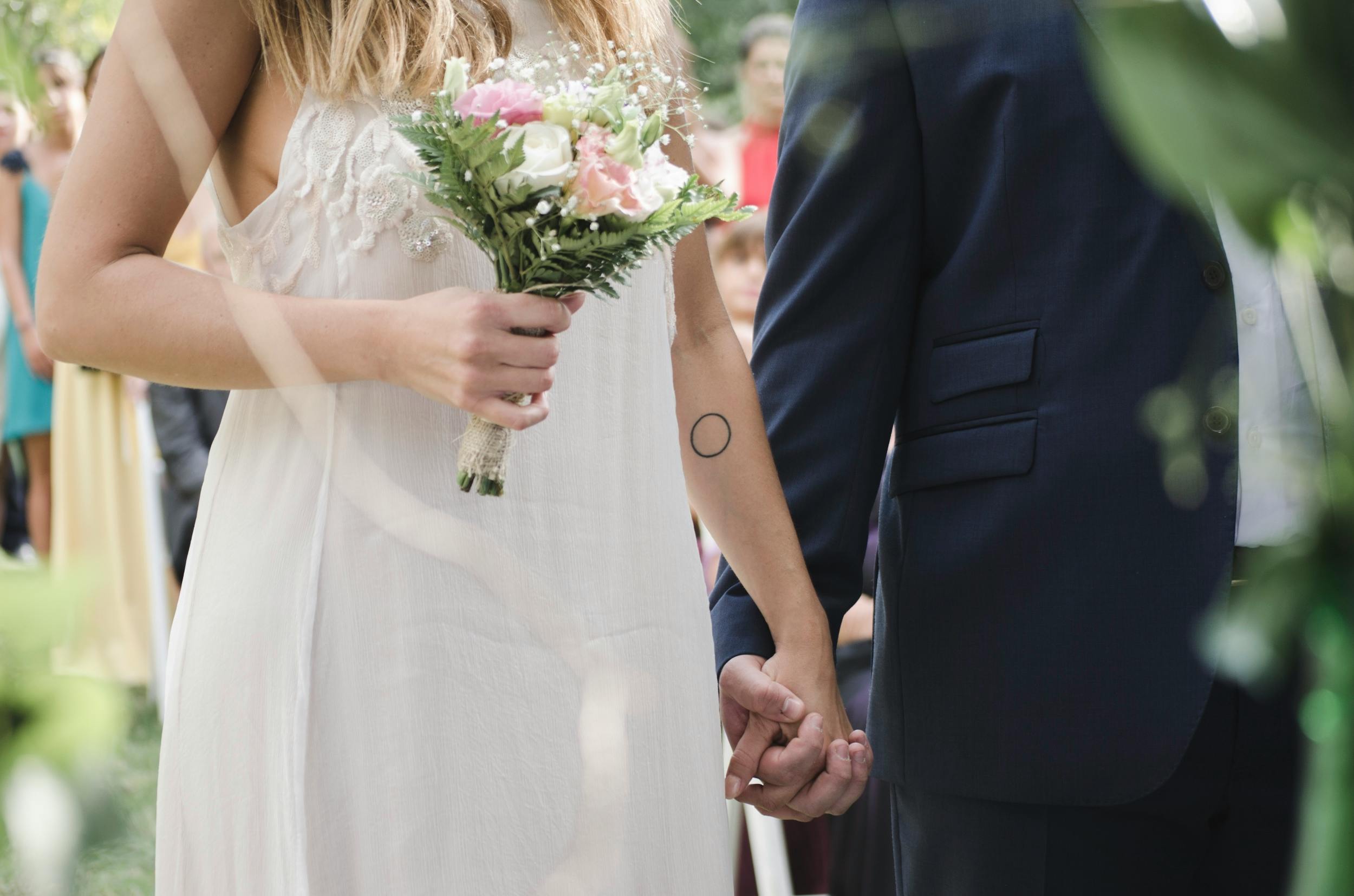 Bride and groom holding hands at wedding ceremony