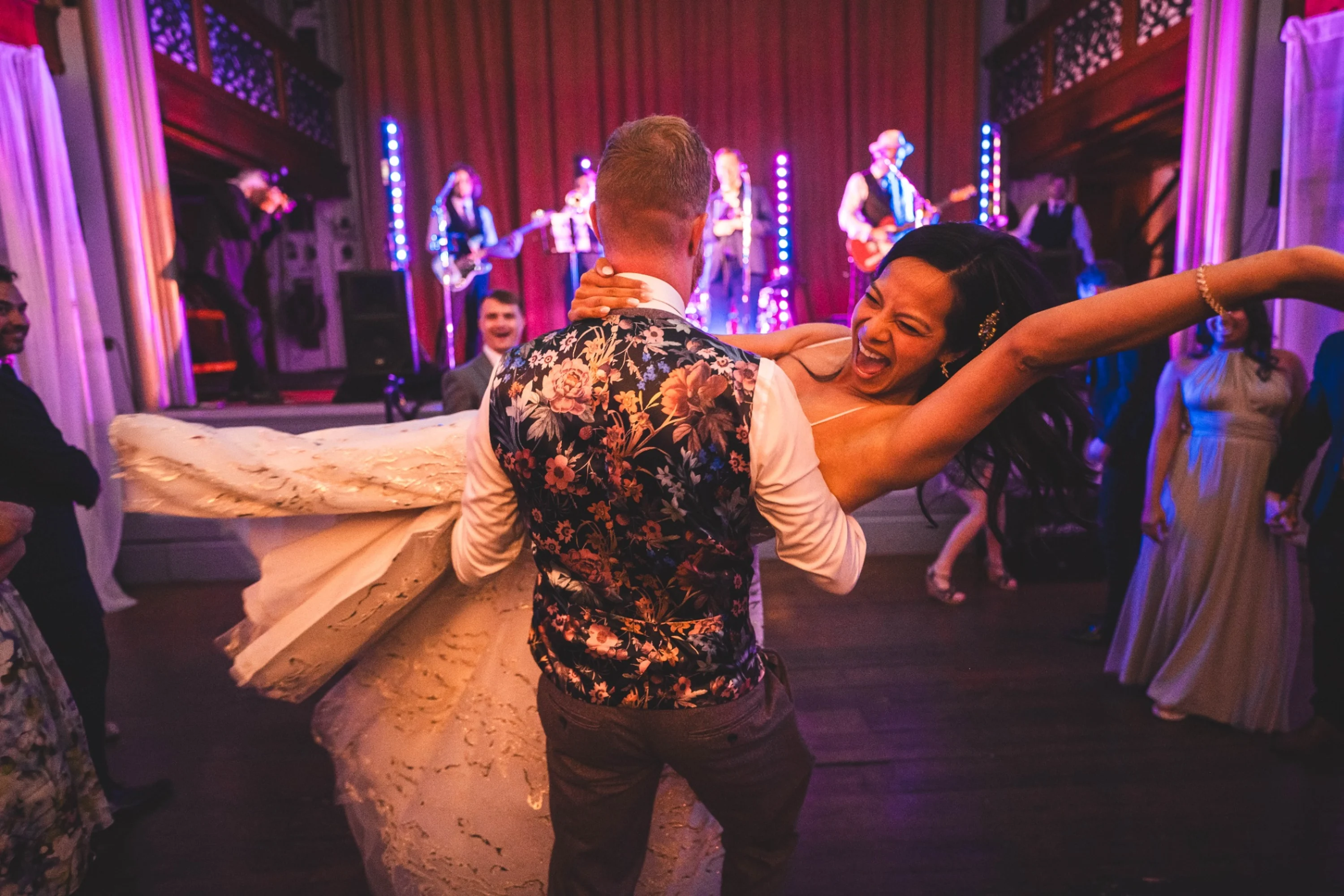 Groom carrying the happy bride onto the dancefloor