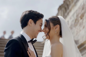 Wedded couple smiling and looking deep into each other's eyes in wedding video