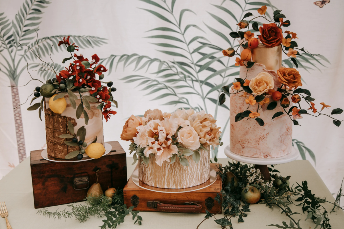 Autumnal wedding cakes on display with floral decorations