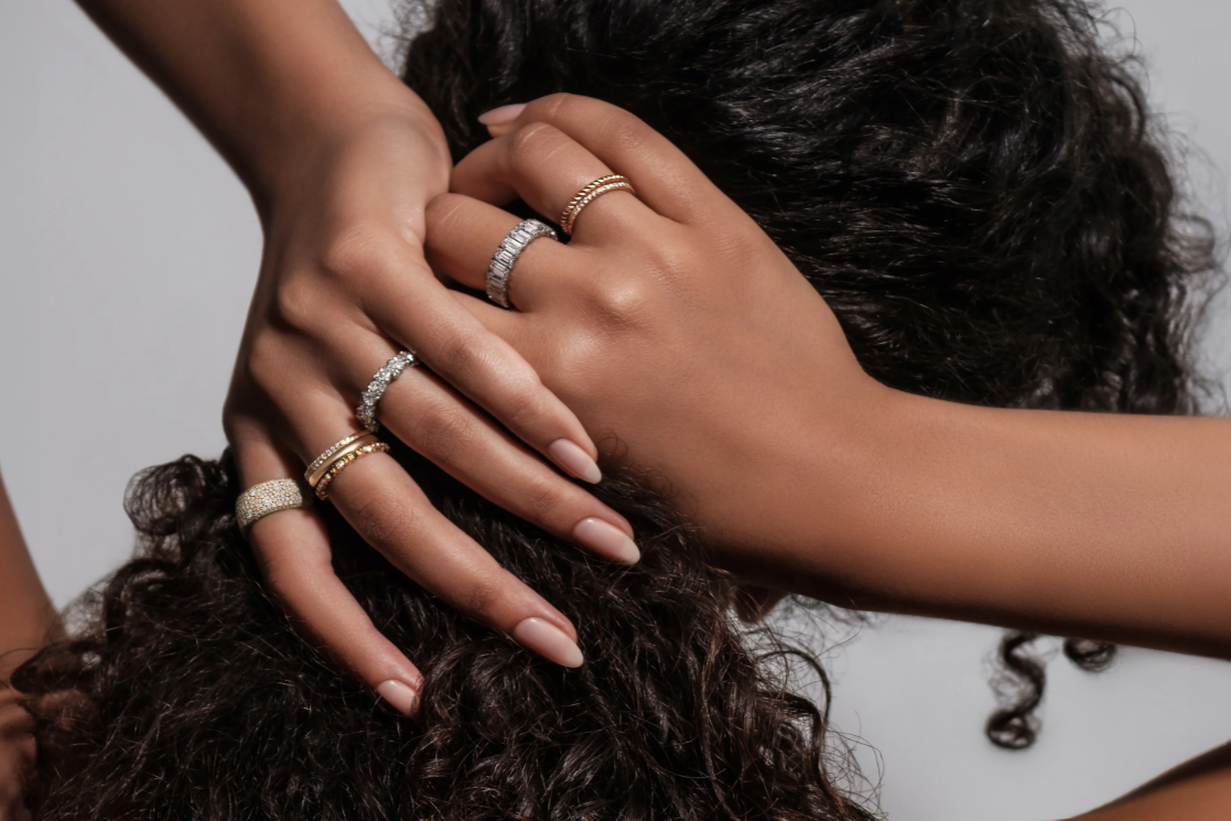 Wedding bands/rings stacked on a woman's hands