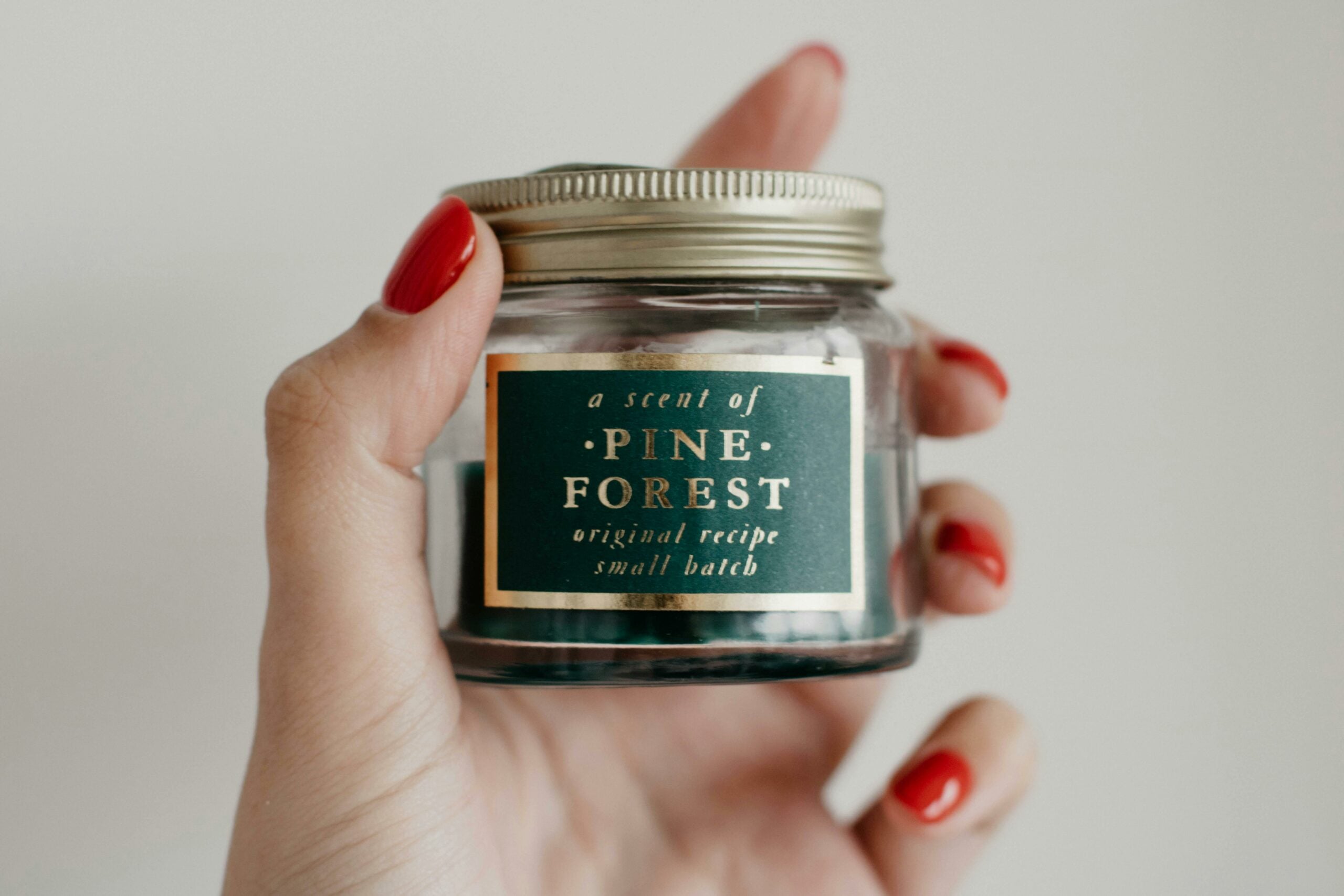 Person holding bath salts in glass jar