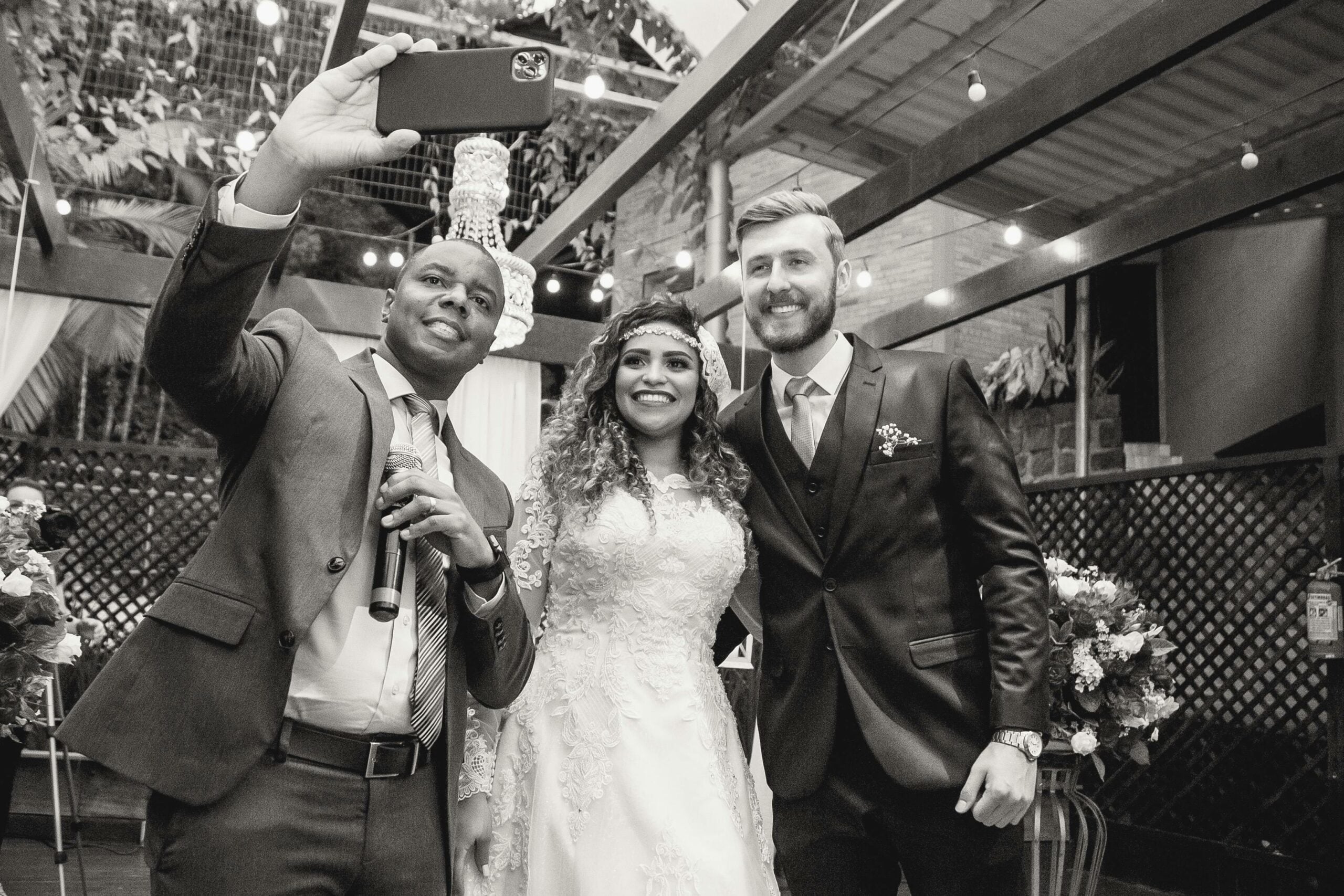 Guest taking a selfie with a bride and groom