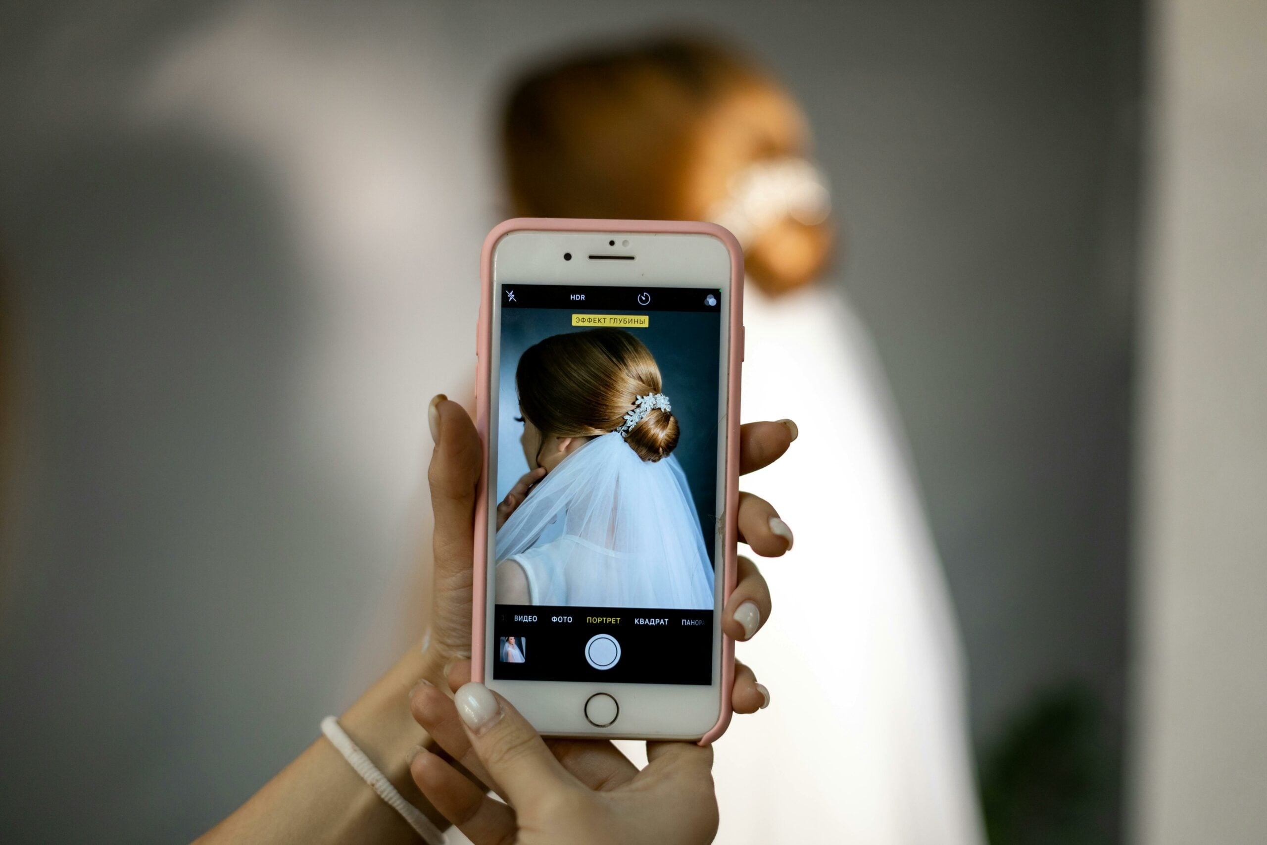 Someone taking a photo of a bride with their phone