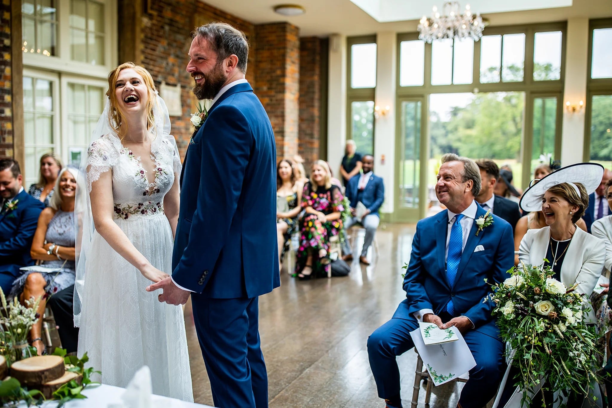 Couple hand in hand laughing during a celebrant led wedding ceremony