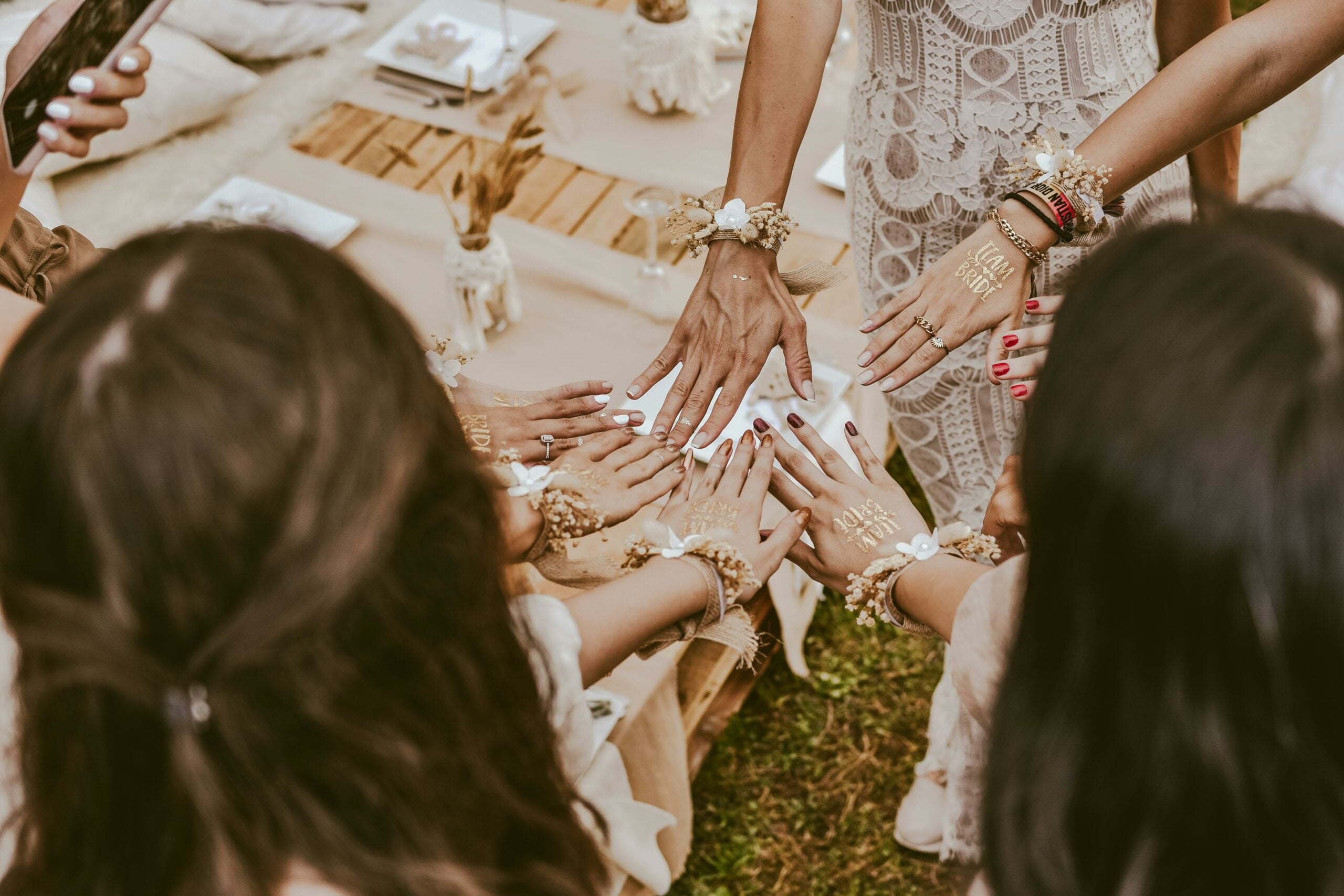 Hens with their hands on show with team bride printed in gold foil