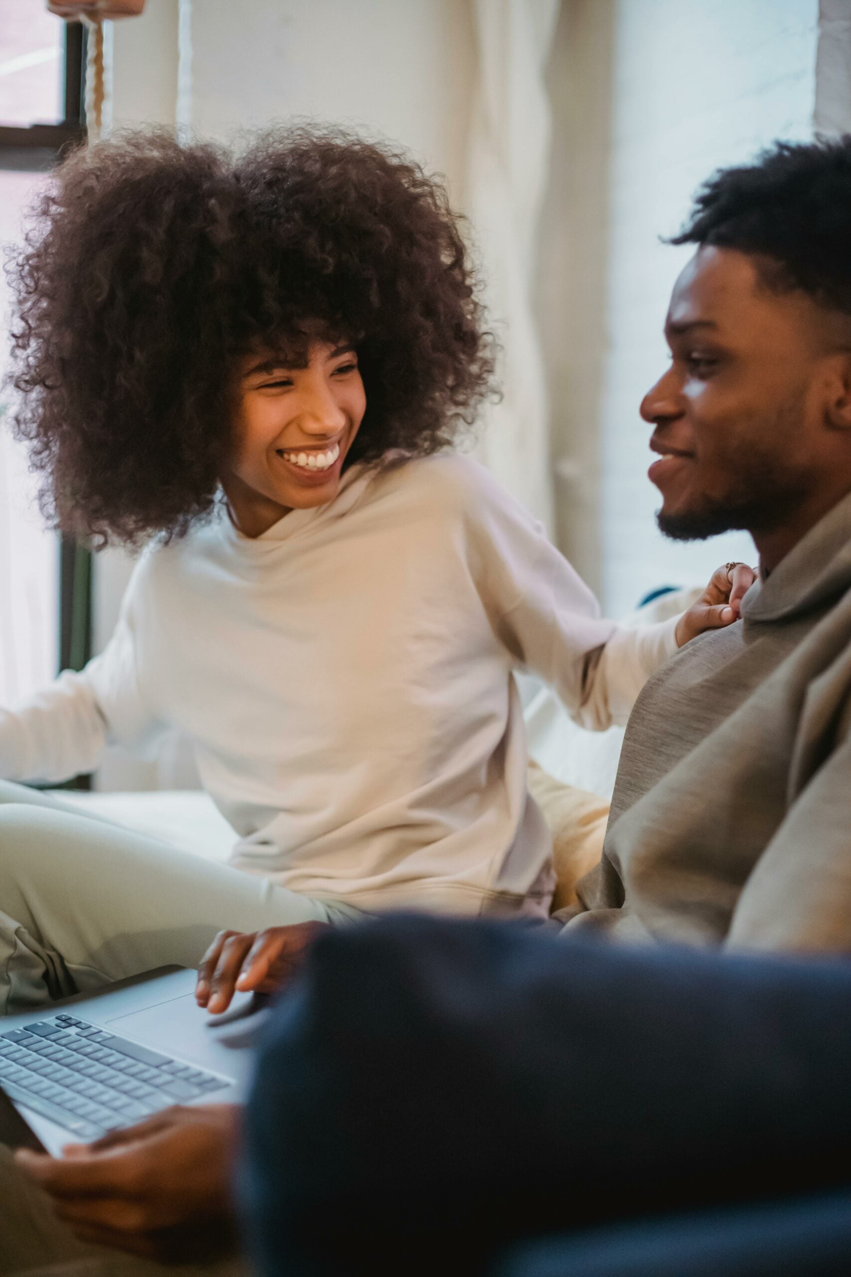 Couple laughing together as they work on a wedding website