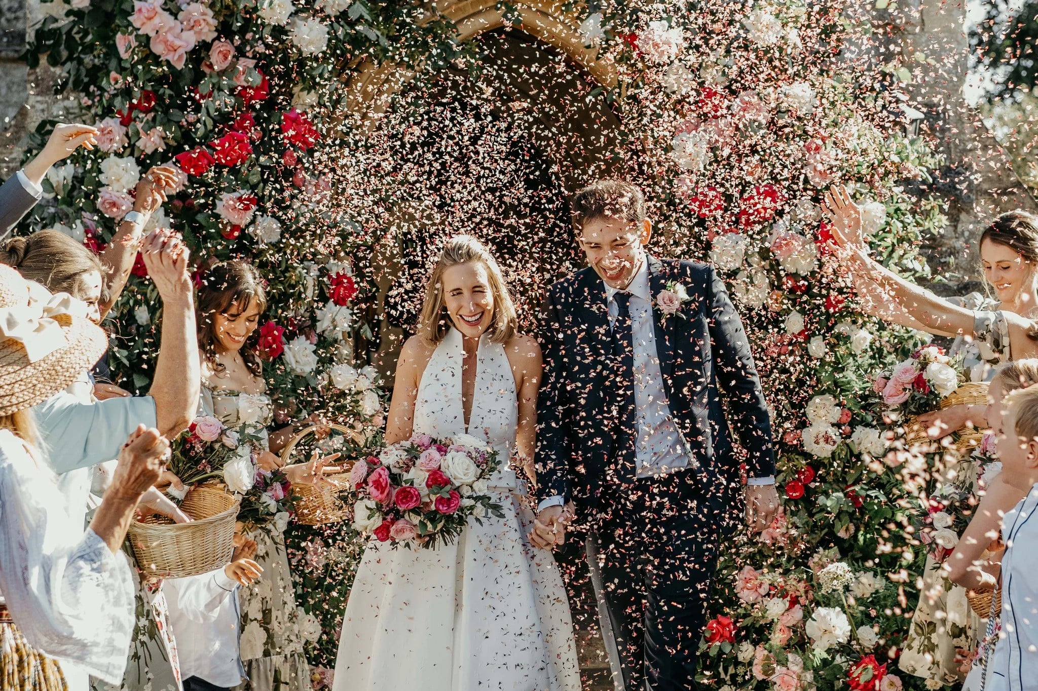 Couple being scattered with confetti outside a traditional church