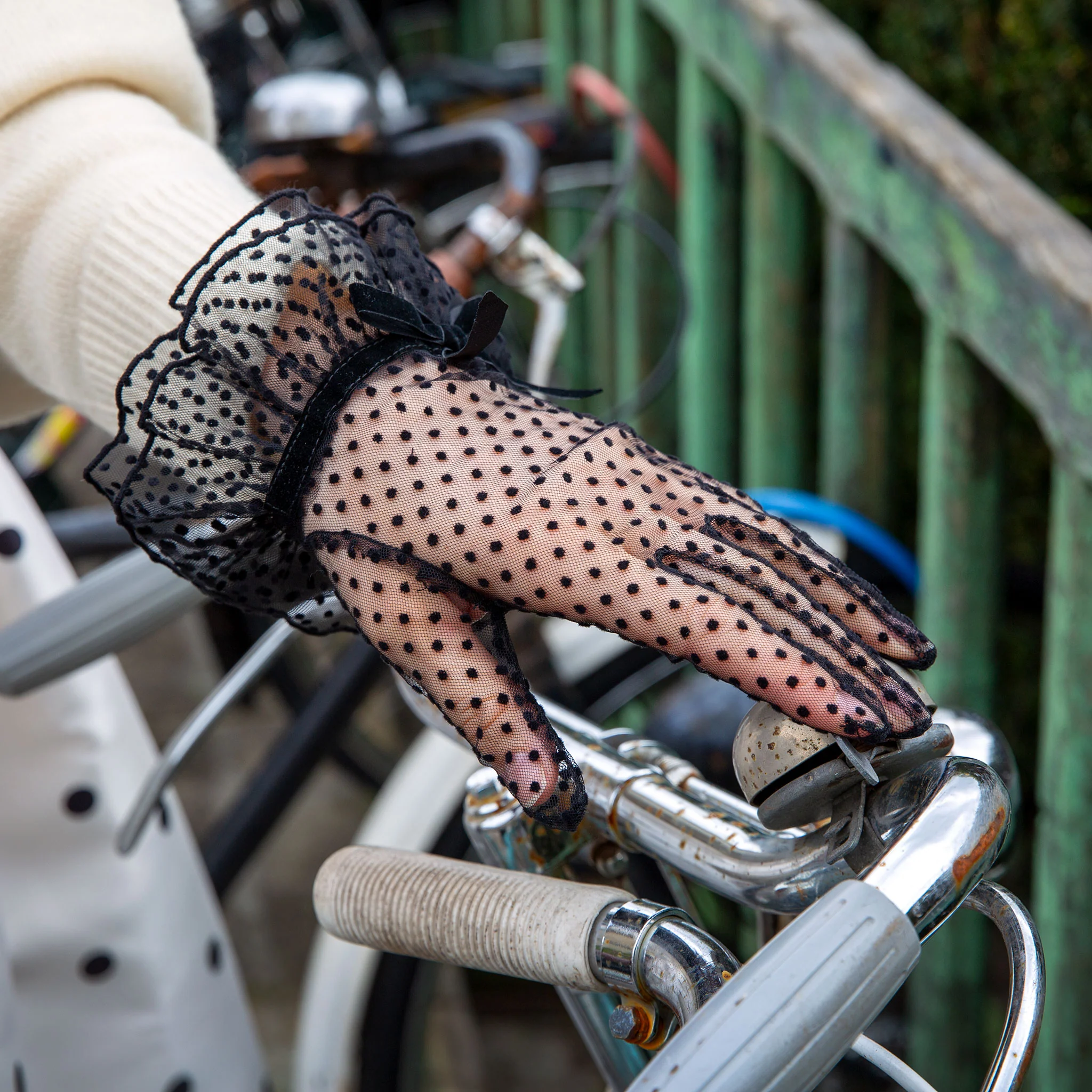 Black polka dot gloves with a ruffled trim