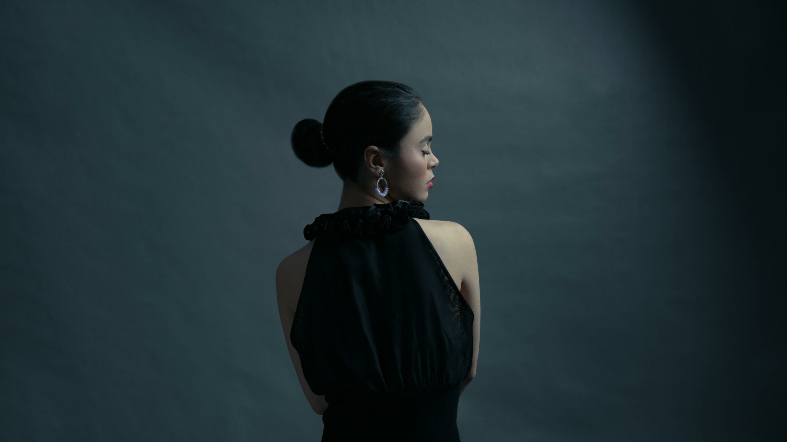side profile of woman showing low sleek bun